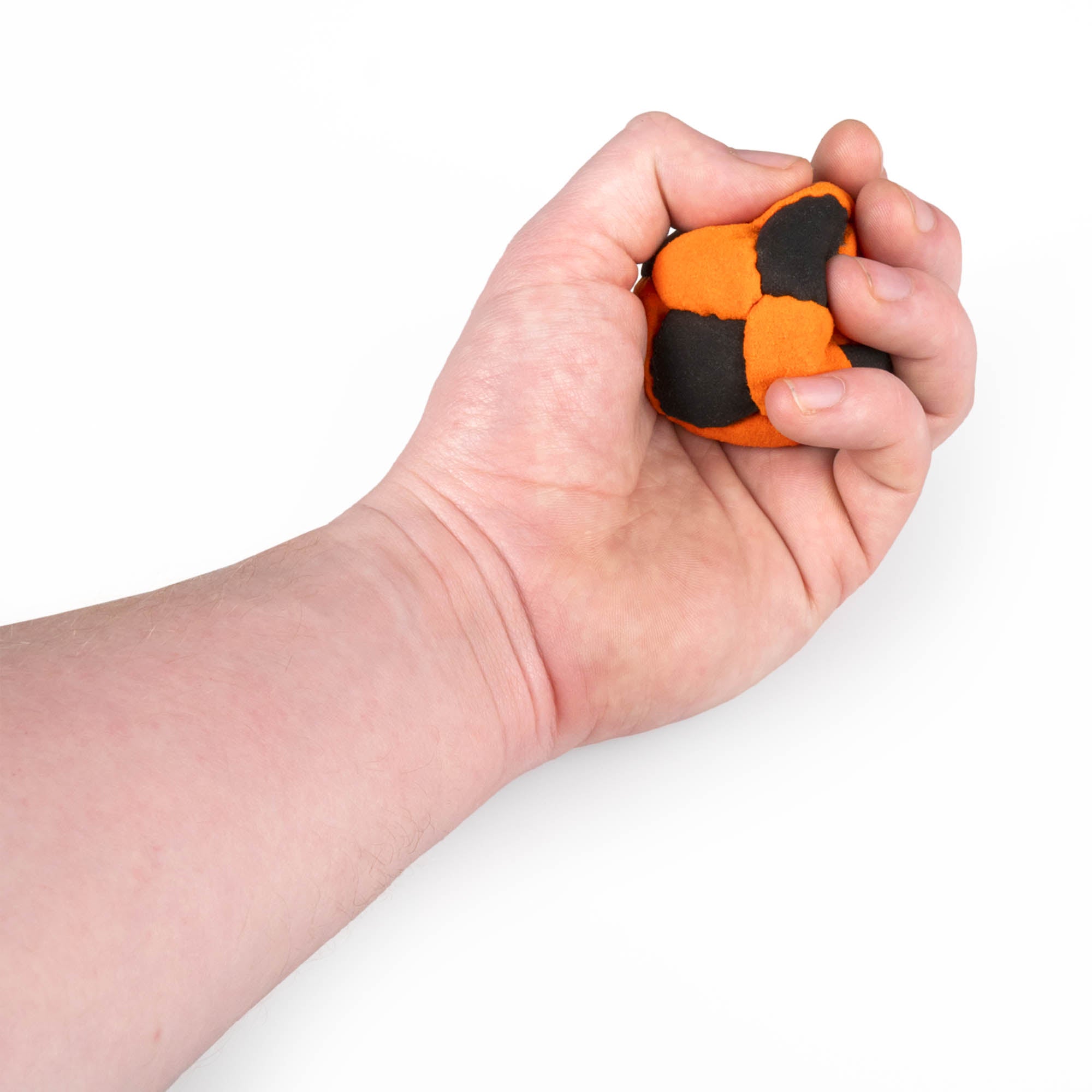 Orange and black hacky sack in hand