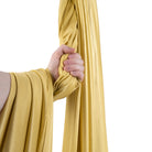 Gold yoga hammock wrapped around hand