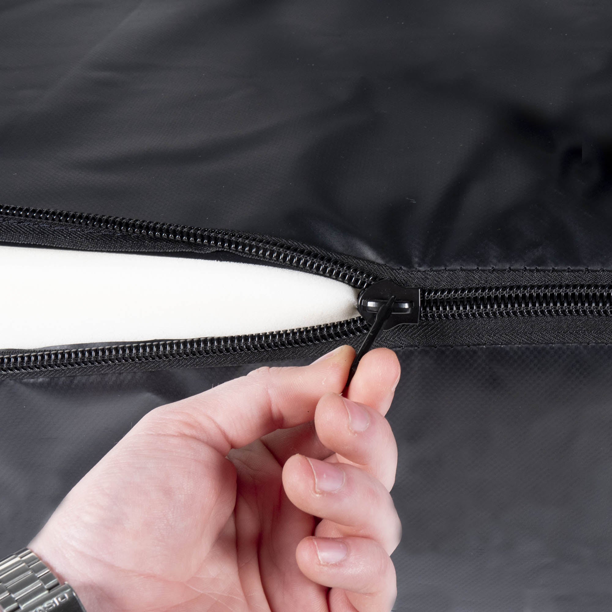 a person using the zip to close the cover