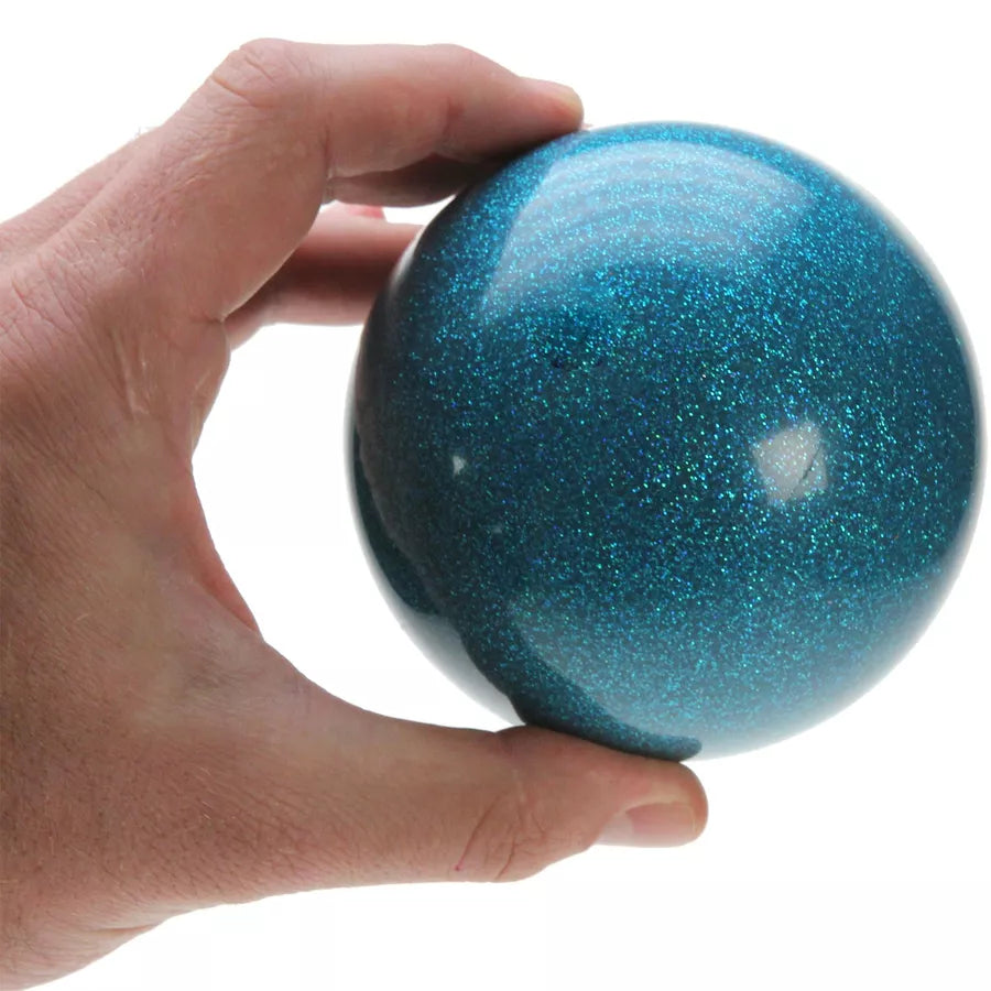 A hand holding a 100mm blue glitter stage ball