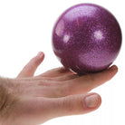 Purple glitter ball on hand