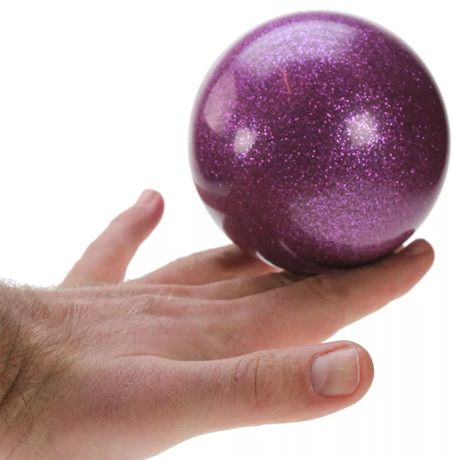 Purple glitter ball on hand