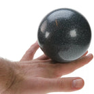 Black glitter ball on hand