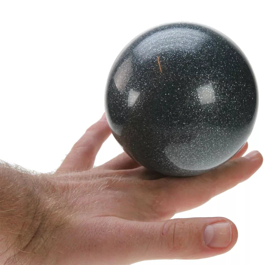 Black glitter ball on hand