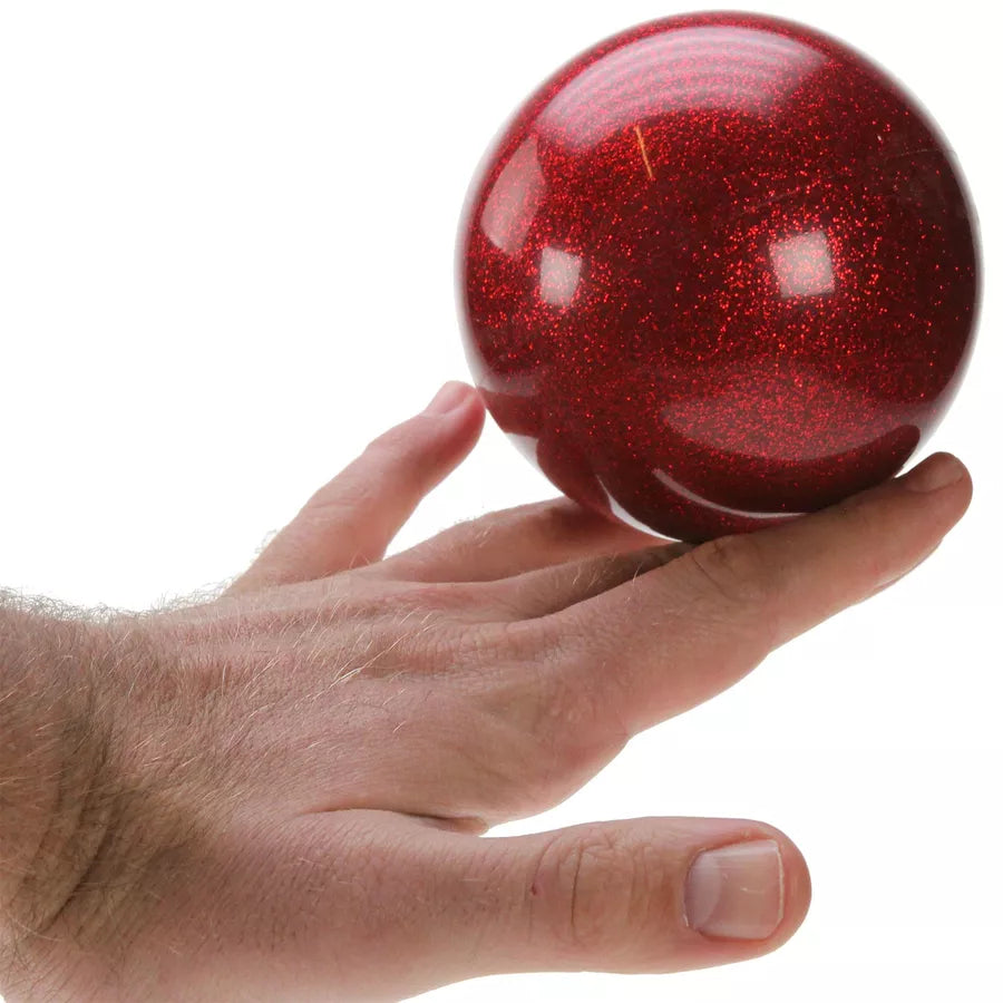 Red glitter ball on hand