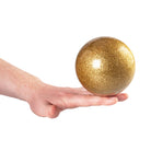 Gold glitter ball on hand