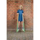 Child standing on wooden stilts