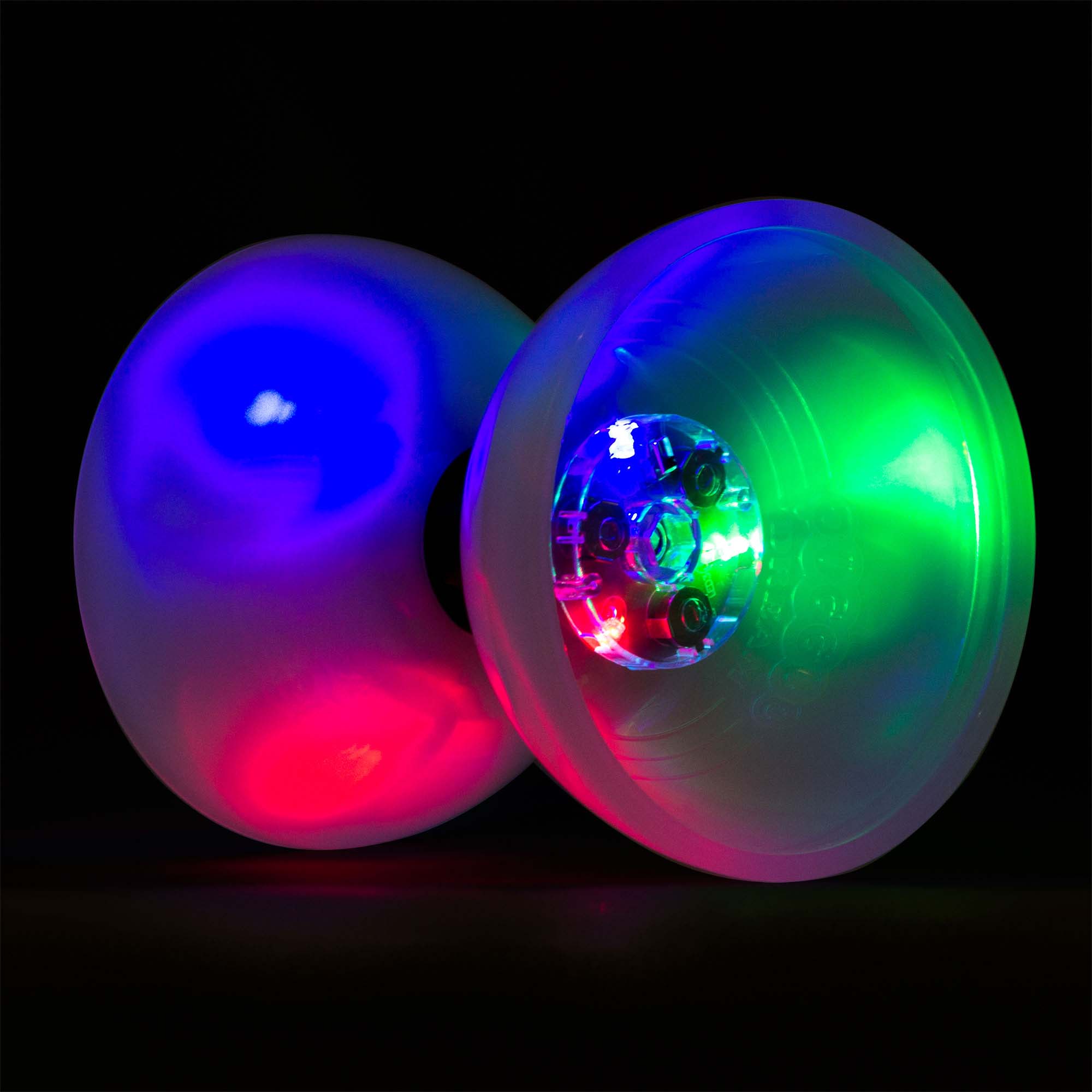 A large diabolo with LED lights visible through its translucent cups, glowing in multiple colors against a dark background.