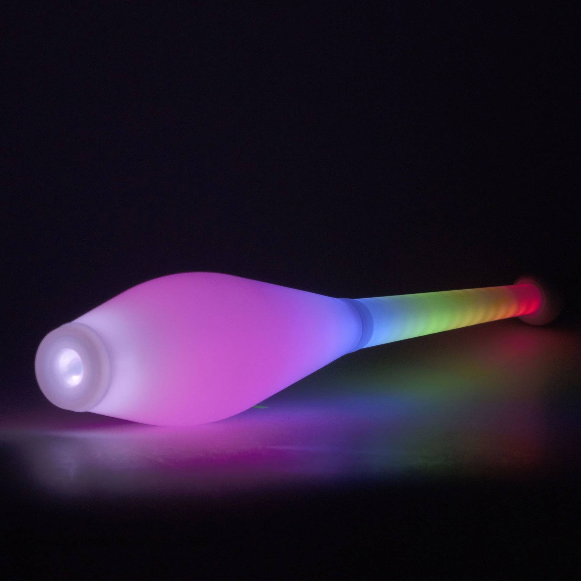 A juggling club emitting multicolored lights against a dark background.