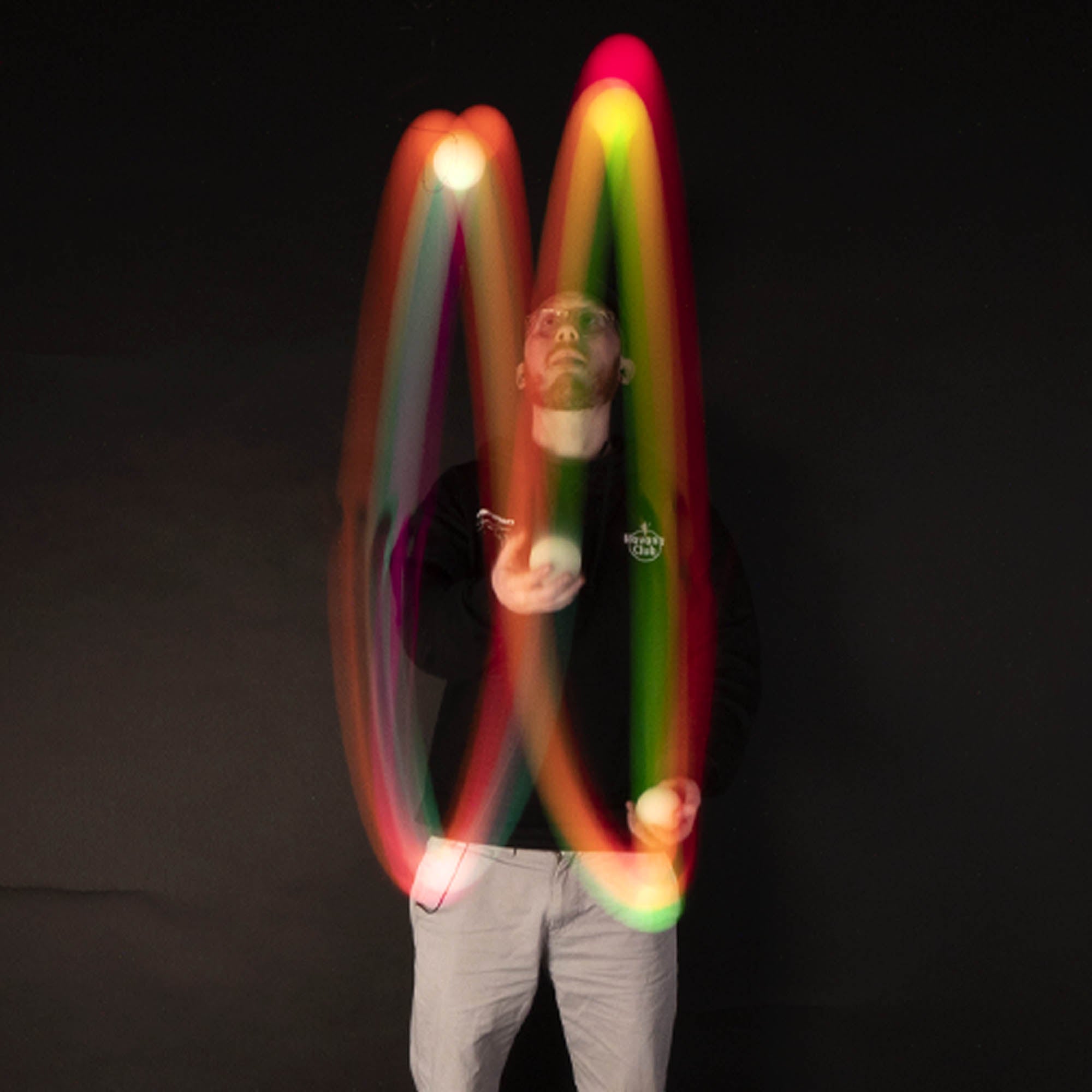 3 balls being juggled with light trails