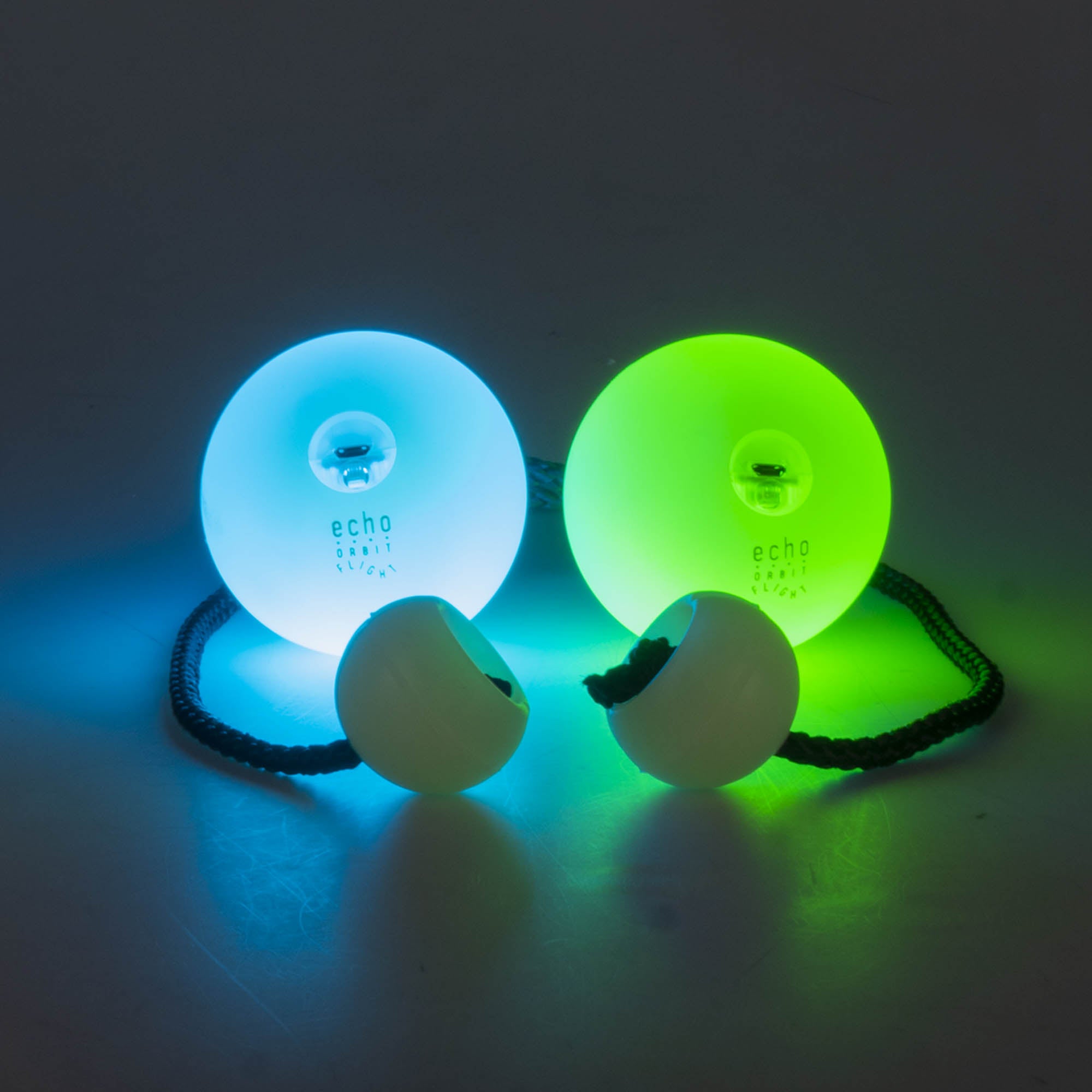 LED poi glowing, one blue, one green
