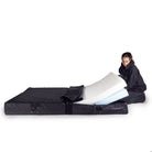 a person inserting foam layers