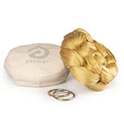 Gold yoga hammock resting on eco bag with O-rings laying in front