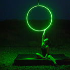 Firetoys x Echo LED Aerial Hoop glowing green illuminating subject 