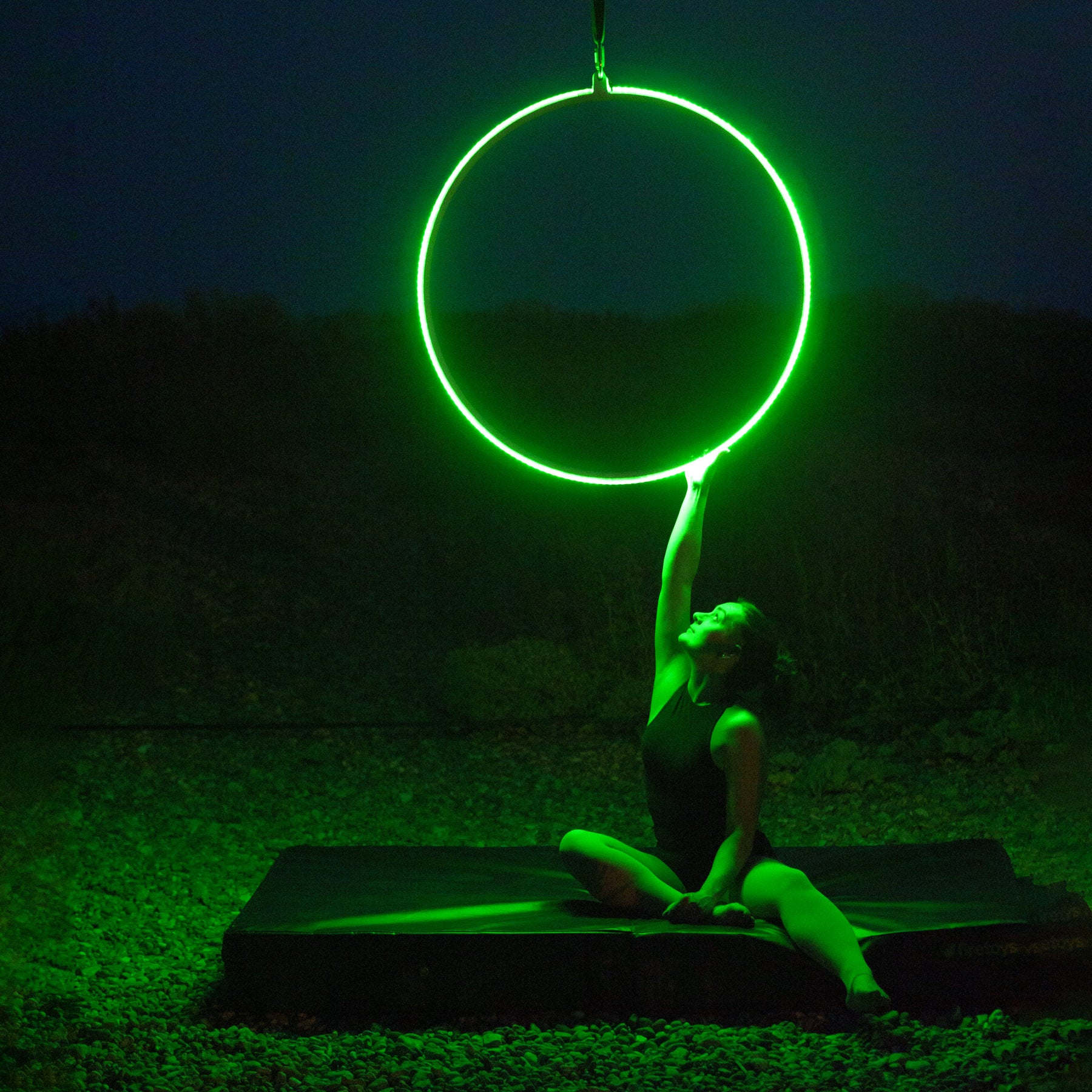 Firetoys x Echo LED Aerial Hoop glowing green illuminating subject 